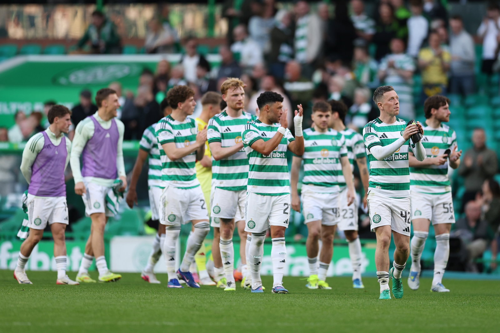 Celtic team acknowledge the fans