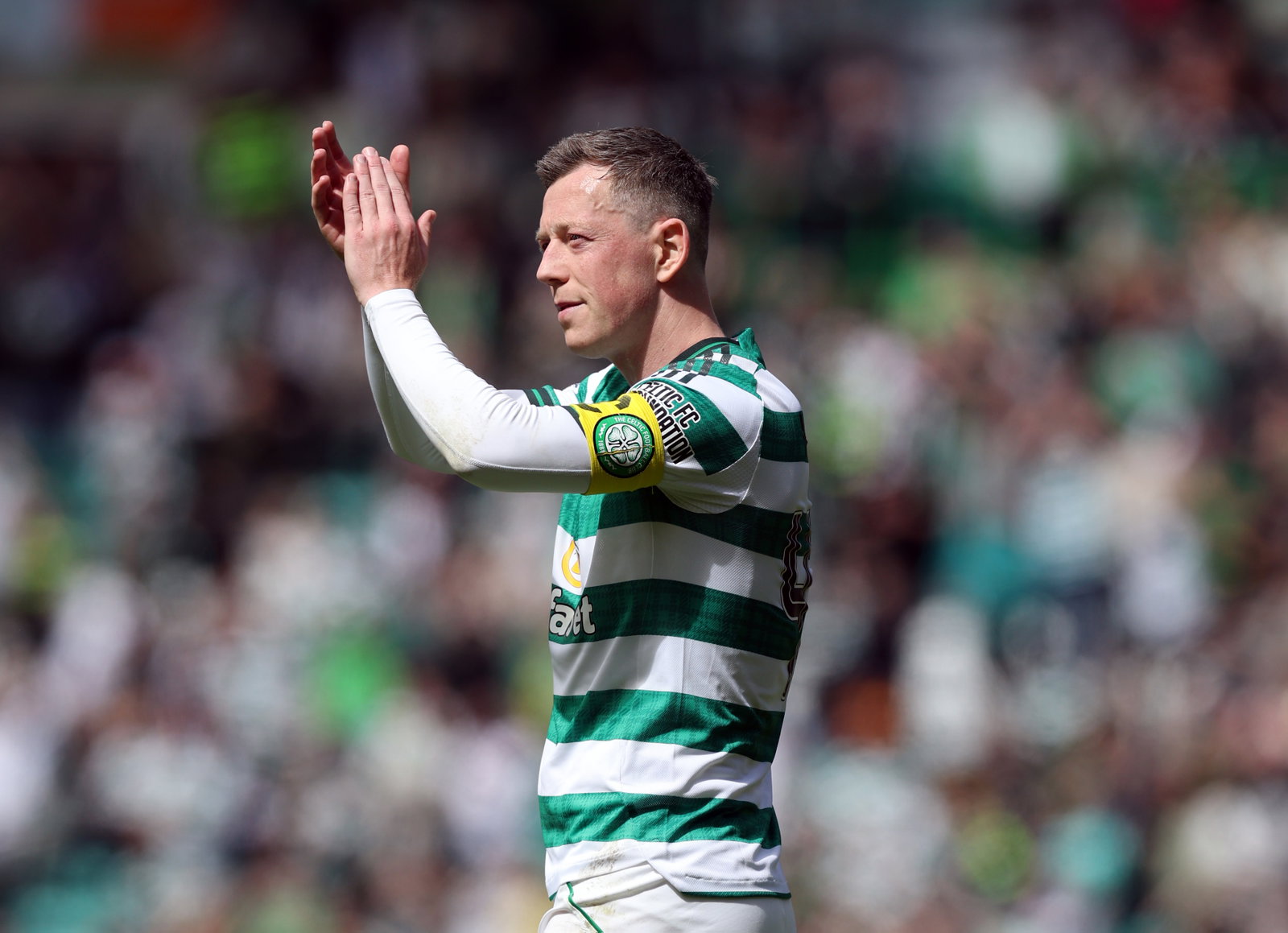 Callum McGregor of Celtic applauds the support...