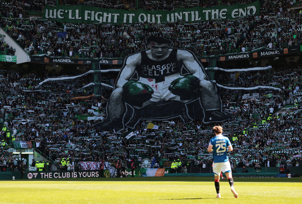 Fans of Celtic display a tifo which reads 'we'll fight it out until the end',