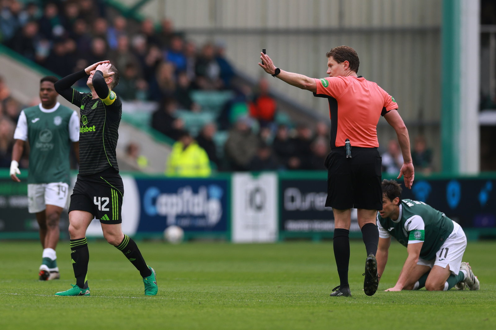 Callum McGregor of Celtic reacts to referee David Dickinson's decision